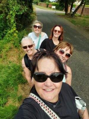 A picture of the retreat group embarking on a therapeutic walk amidst the lush green Suffolk countryside, enjoying the tranquillity and natural beauty